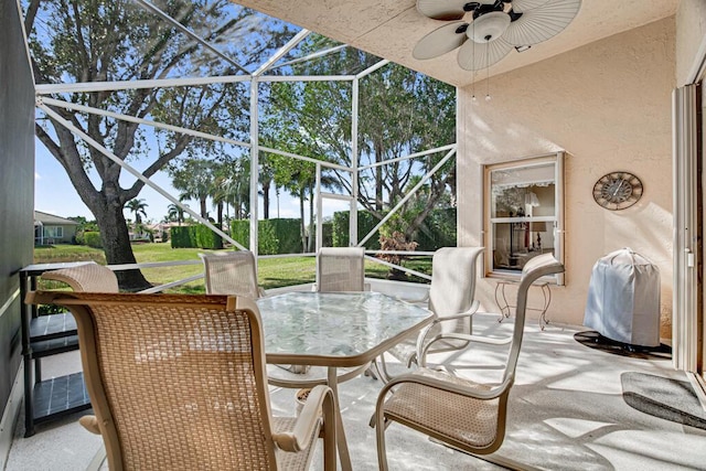 sunroom featuring ceiling fan