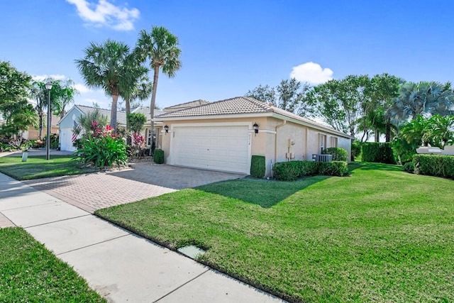 view of side of property with a garage, central AC unit, and a lawn