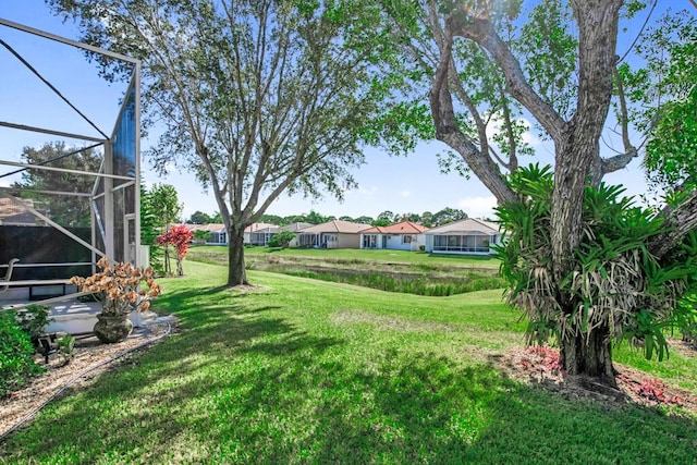 view of yard featuring glass enclosure