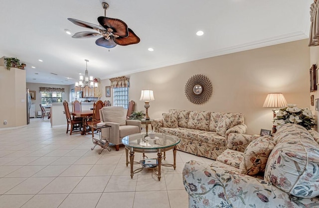 tiled living room with ceiling fan with notable chandelier and crown molding