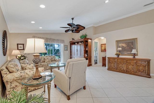 living room featuring light tile patterned floors, ceiling fan, and crown molding