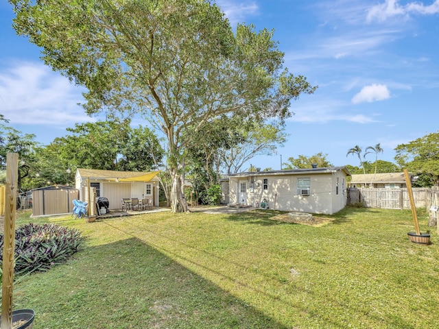 view of yard featuring a patio area and a shed