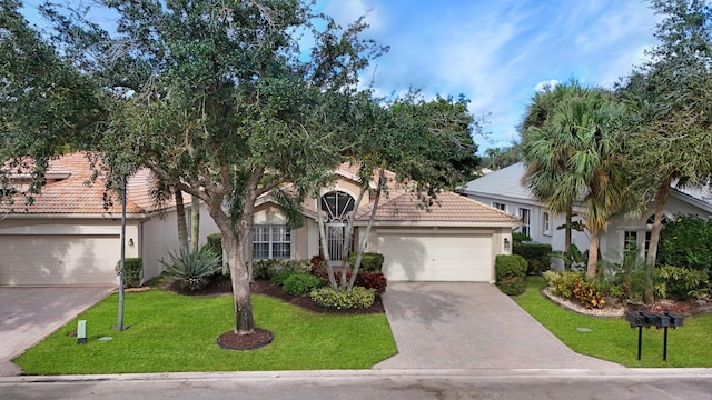 view of front of home with a front lawn and a garage