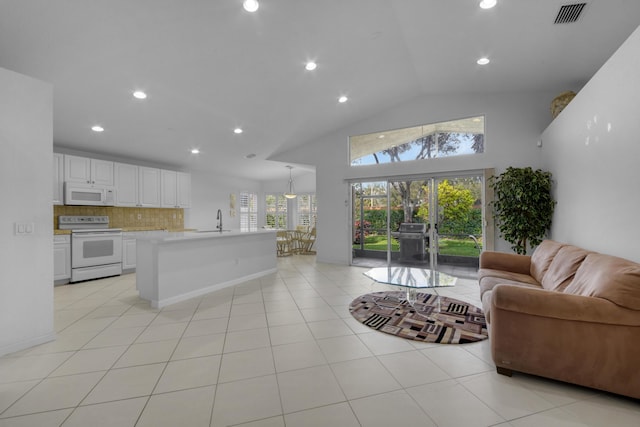 interior space featuring high vaulted ceiling, sink, and french doors