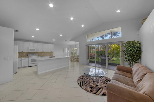 tiled living room with high vaulted ceiling and sink