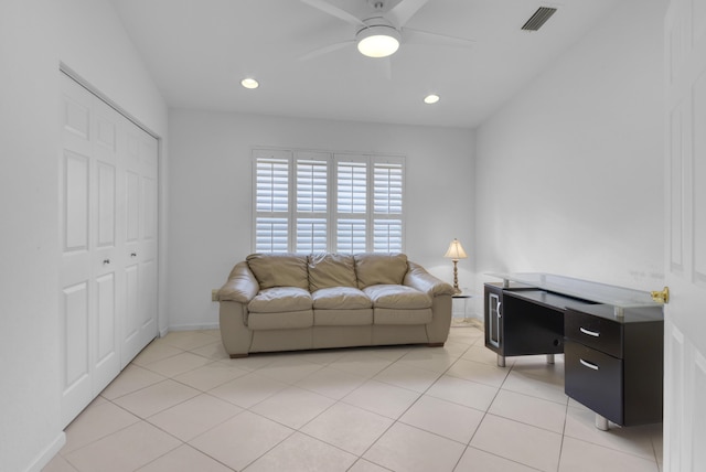 living room with ceiling fan and light tile patterned floors