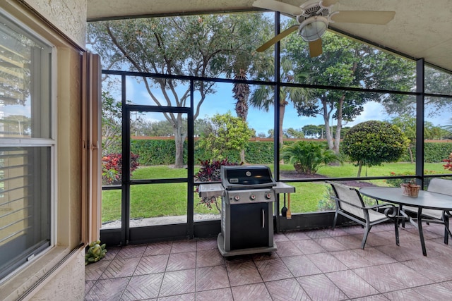 unfurnished sunroom with ceiling fan