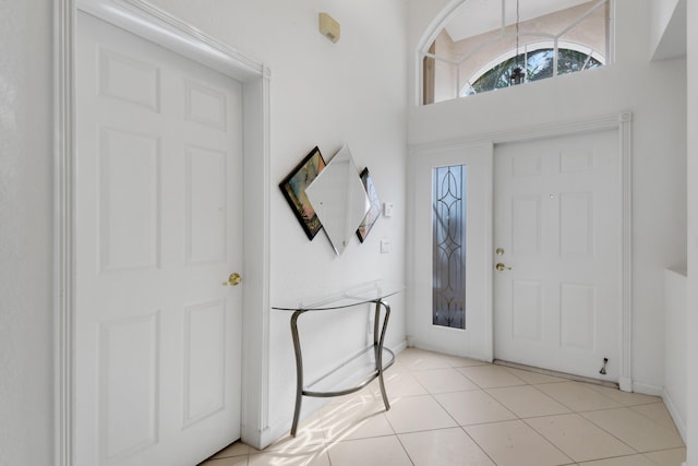 tiled entryway with a towering ceiling