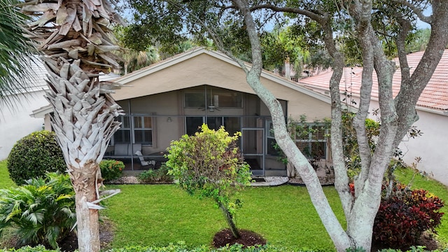 exterior space with a sunroom and a yard