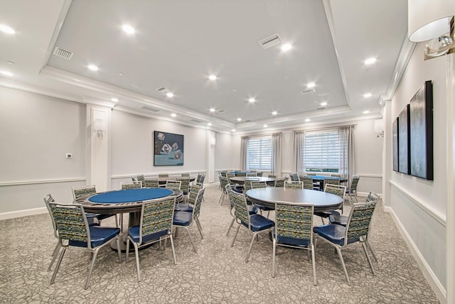 dining space featuring crown molding and a raised ceiling