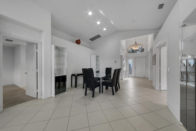 tiled dining space with lofted ceiling