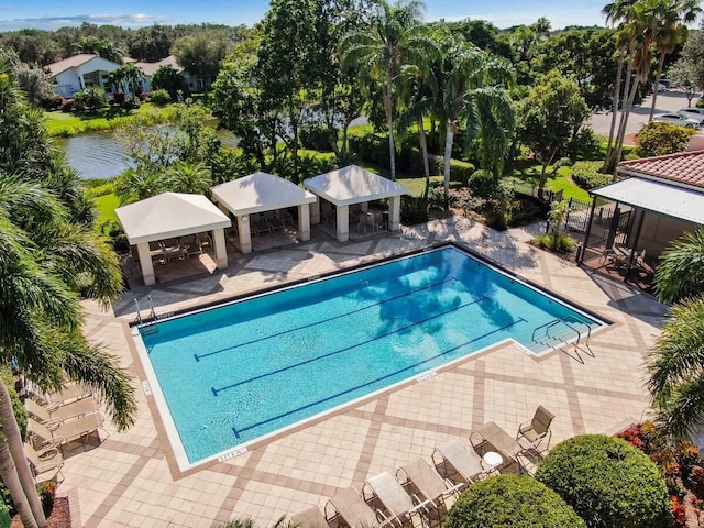 view of pool with a water view, a gazebo, and a patio