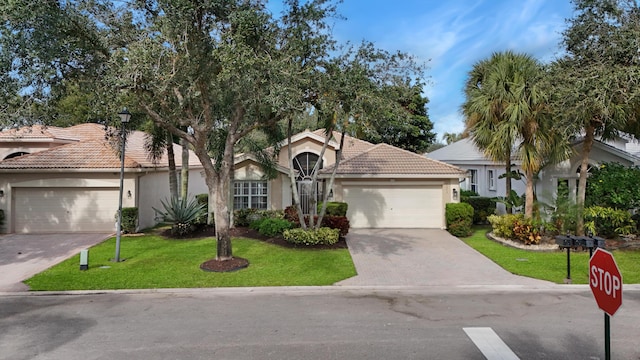 view of front facade featuring a front lawn and a garage