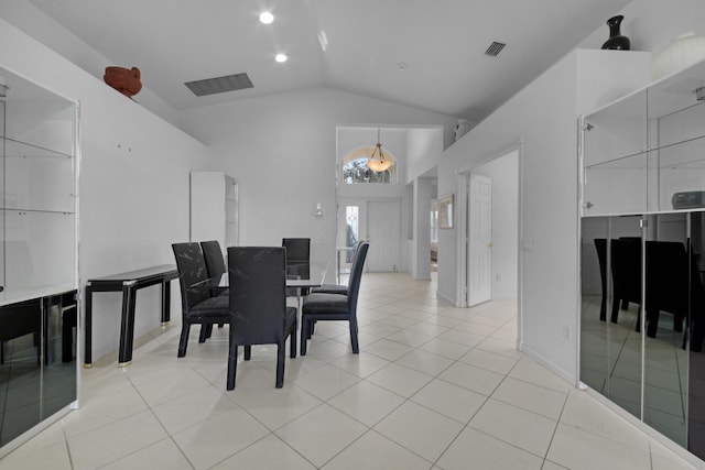 dining room featuring vaulted ceiling, an inviting chandelier, and light tile patterned floors