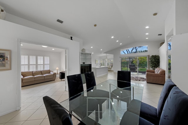 dining room with vaulted ceiling and light tile patterned floors