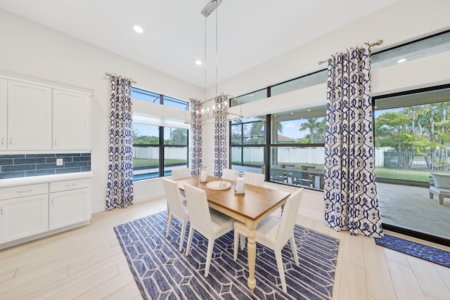 dining area with light hardwood / wood-style flooring and a healthy amount of sunlight