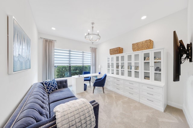 office with light colored carpet and an inviting chandelier