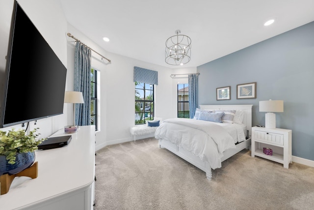 carpeted bedroom with a chandelier