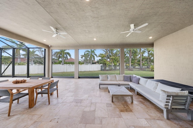 sunroom with ceiling fan