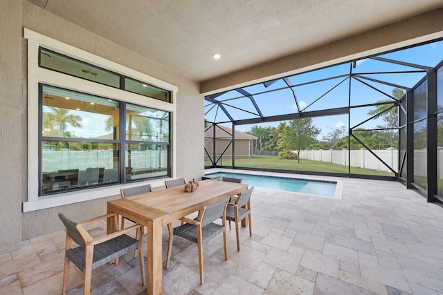 view of swimming pool with glass enclosure, a yard, and a patio