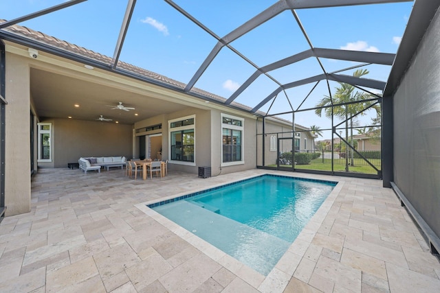 view of swimming pool with outdoor lounge area, a patio area, ceiling fan, and a lanai