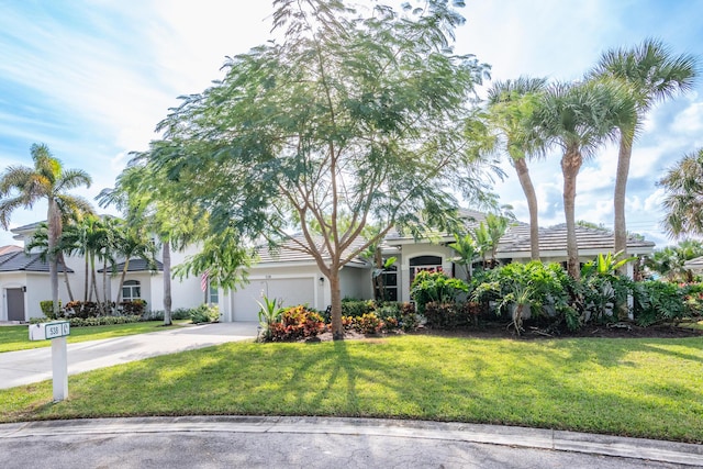 view of front of home with a front lawn and a garage