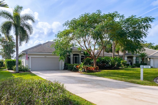 view of front of home featuring a garage and a front lawn