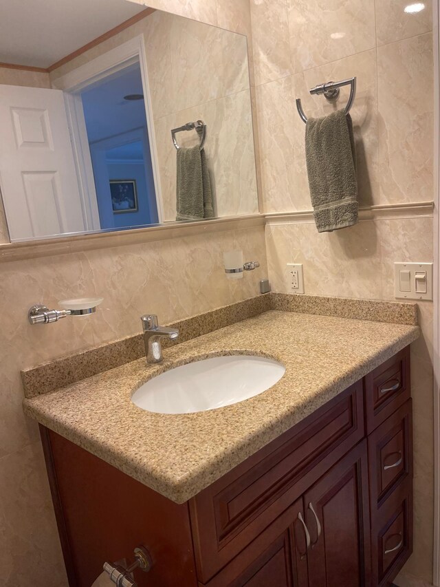 bathroom with vanity, tile walls, and backsplash