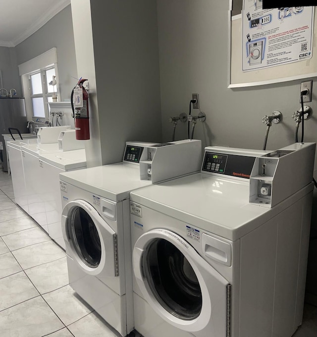 laundry room with separate washer and dryer, crown molding, and light tile patterned flooring