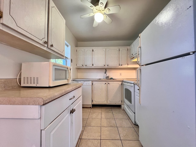 kitchen with ceiling fan, sink, light tile patterned floors, white appliances, and white cabinets