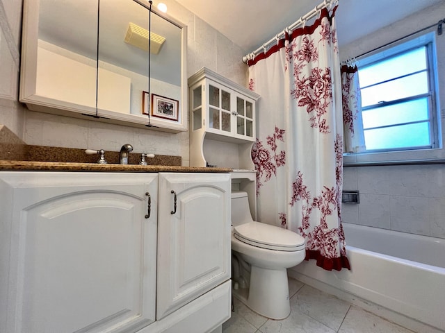 full bathroom featuring toilet, shower / bath combination with curtain, vanity, and tile patterned floors