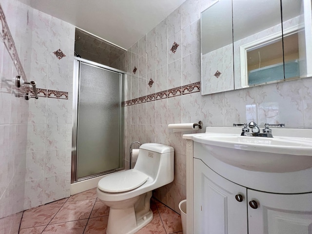 bathroom featuring tile patterned floors, an enclosed shower, vanity, tile walls, and toilet