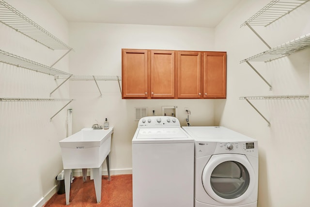 laundry room with separate washer and dryer, carpet, and cabinets