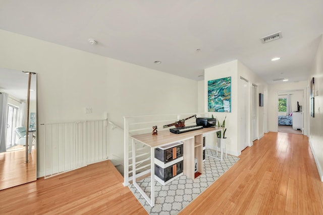 hallway with light hardwood / wood-style flooring