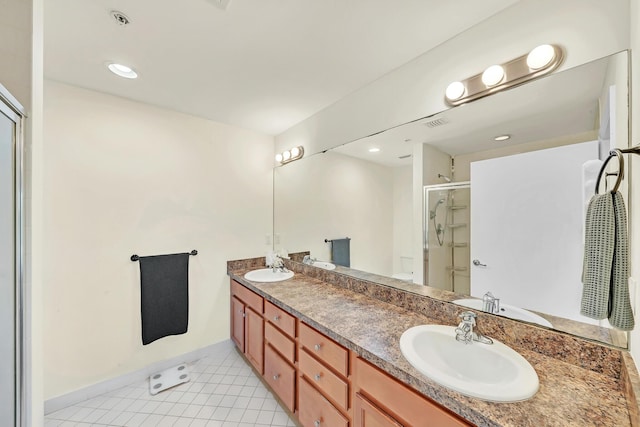 bathroom with tile patterned flooring, vanity, and a shower with shower door