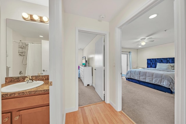 interior space featuring light hardwood / wood-style floors, ceiling fan, and sink