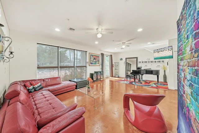 living room featuring ceiling fan and concrete flooring