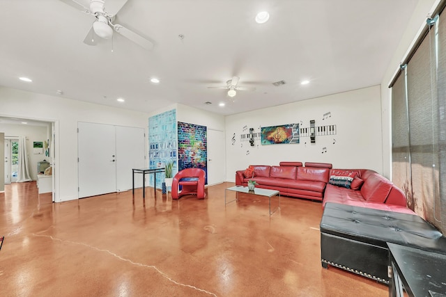 living room with ceiling fan and concrete floors