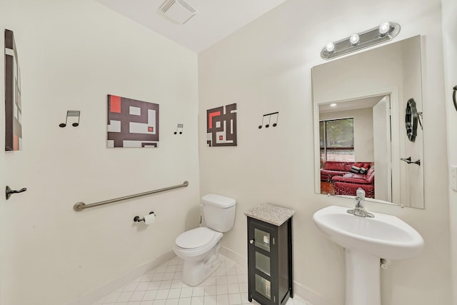 bathroom with tile patterned floors and toilet