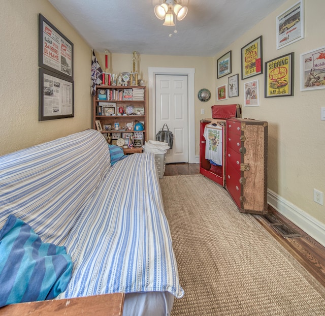 bedroom featuring wood-type flooring and a textured ceiling