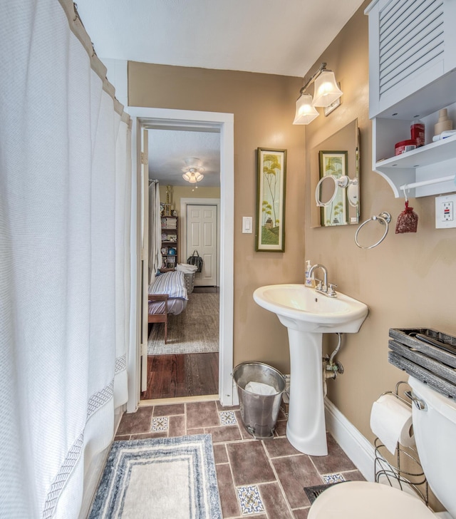 bathroom with wood-type flooring and toilet