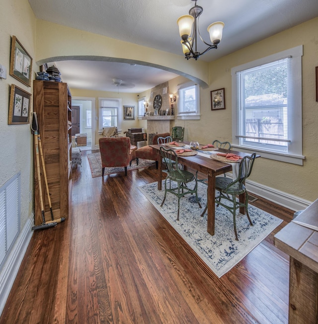 dining room with dark hardwood / wood-style flooring and a notable chandelier