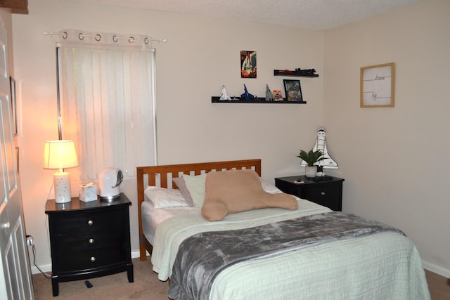 carpeted bedroom with a textured ceiling