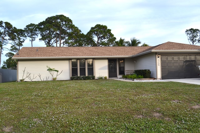 ranch-style house featuring a front yard and a garage