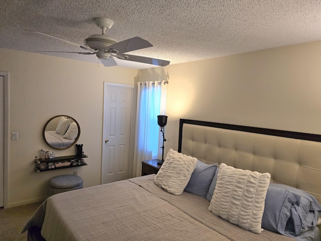 carpeted bedroom with a textured ceiling and ceiling fan