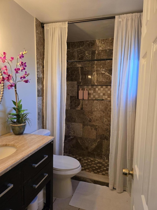 bathroom with walk in shower, vanity, and toilet