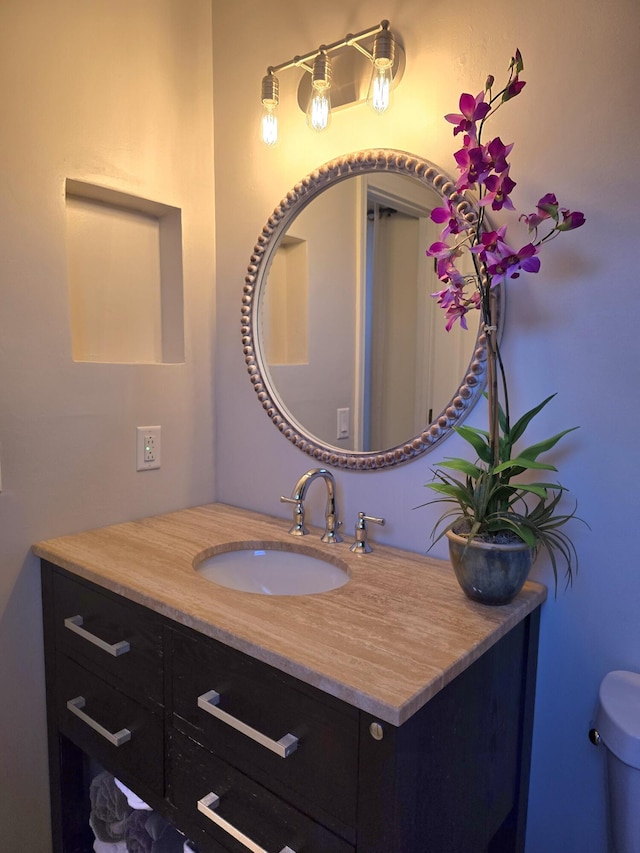 bathroom featuring vanity and toilet