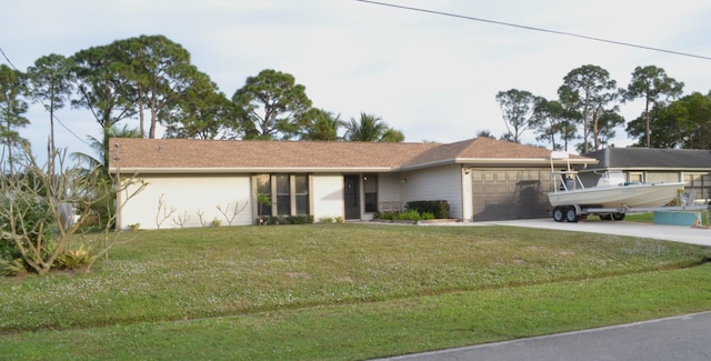 ranch-style house featuring a front lawn and a garage