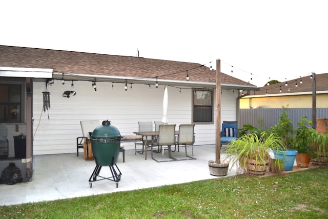 back of house featuring a lawn and a patio