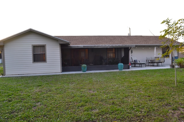 rear view of house featuring a sunroom, a yard, a patio, and an outdoor living space